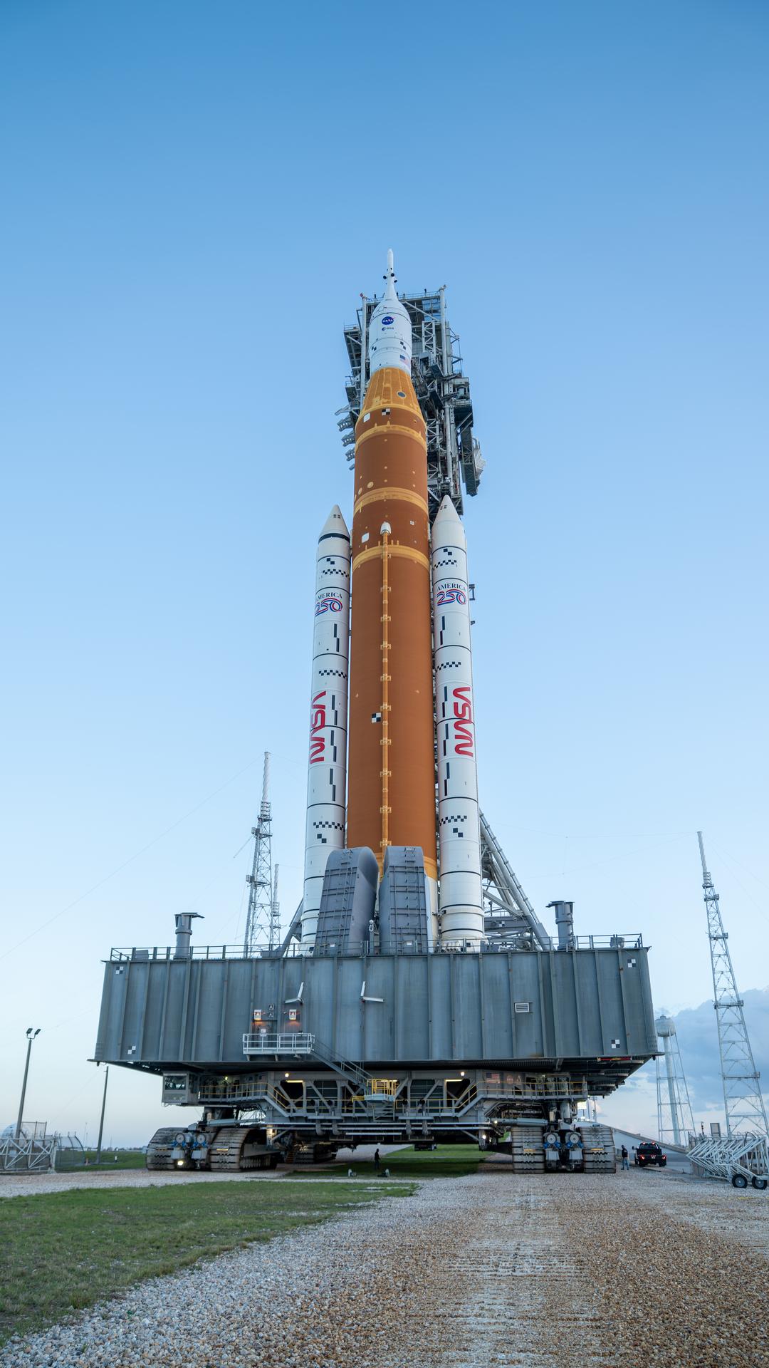This image shows NASA’s SLS (Space Launch System) and Orion spacecraft rolling out of the Vehicle Assembly Building at NASA’s Kennedy Space Center. NASA's massive Crawler-Transporter, upgraded for the Artemis program, carries the powerful SLS rocket and Orion spacecraft on the Mobile Launcher from the Vehicle Assembly Building to Launch Pad 39B at Kennedy Space Center in preparation for the Artemis II mission. 
